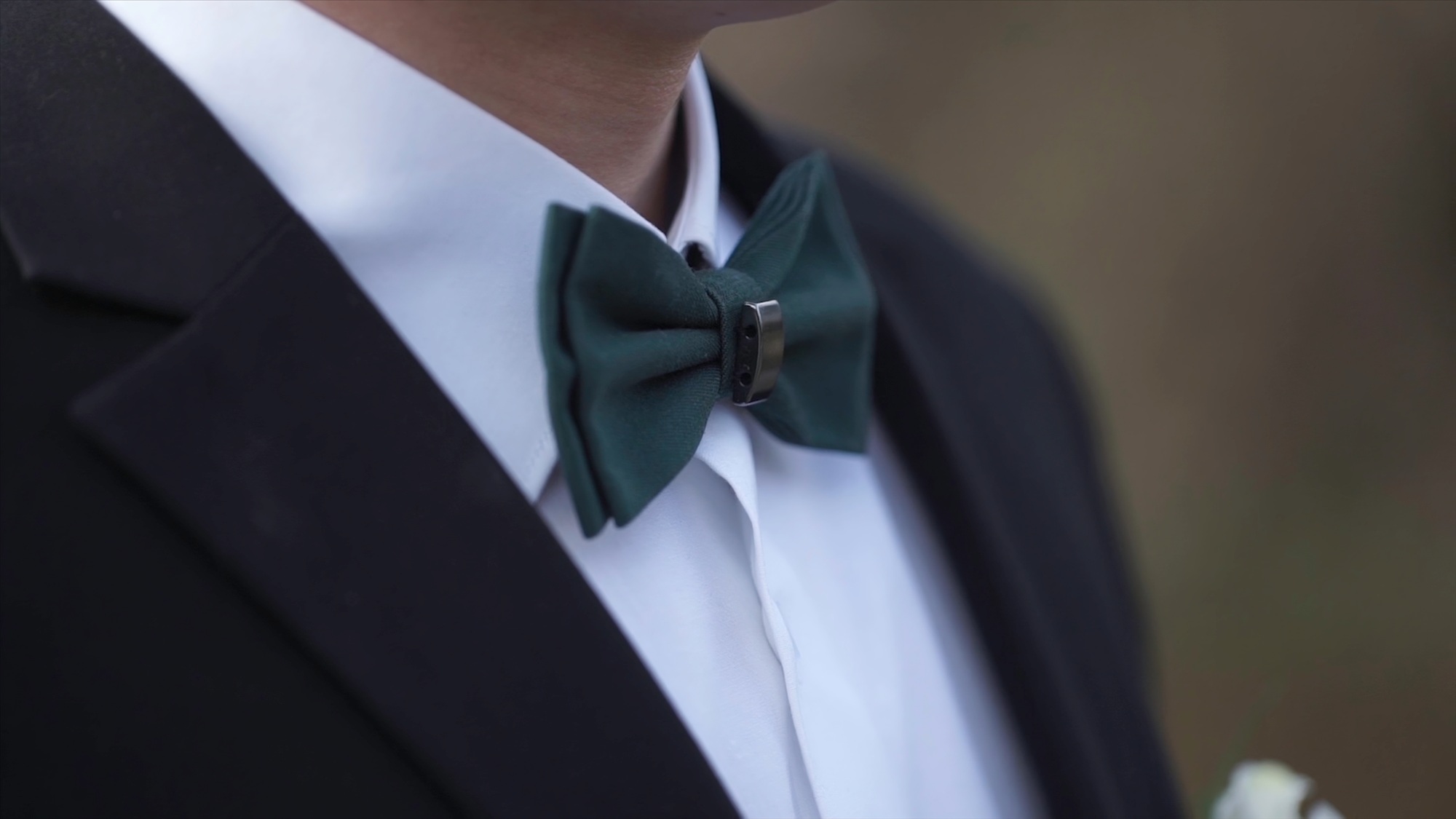 Close-up on nerd, man in bow tie. Man's hands touches bow-tie on a suit or tuxedo. man in a shirt