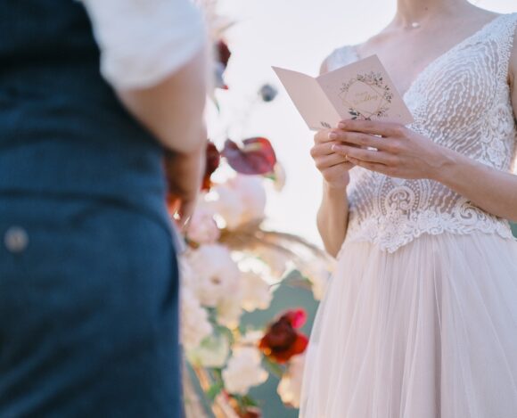 The bride reads a wedding speech to groom. Beautiful moment from a wedding ceremony in nature.