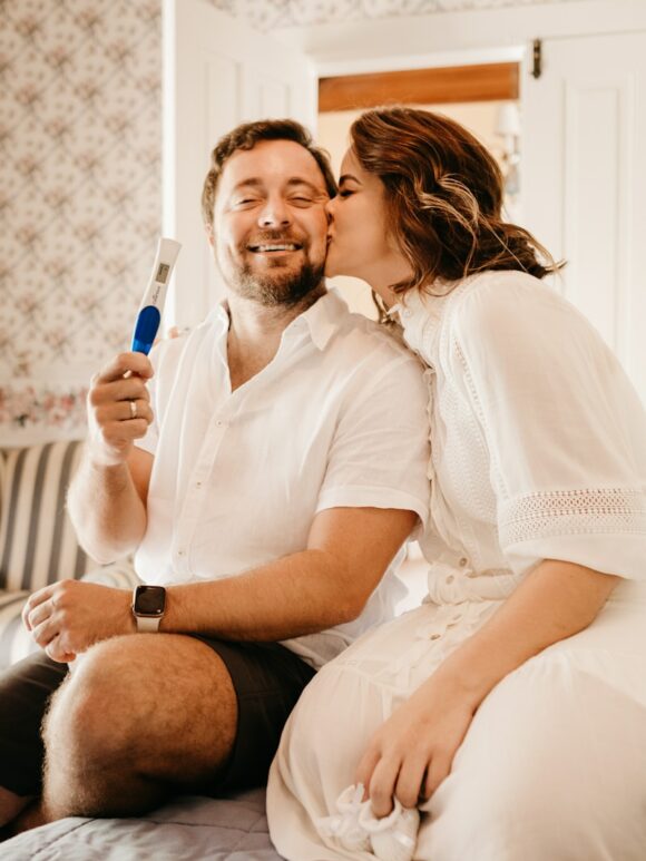 man in white button up shirt sitting beside woman in white shirt
